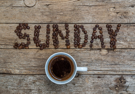 48071044-cup-of-coffee-on-wooden-background-and-sunday-coffee-beans.jpg