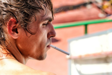 A man with a cigarette in his mouth.