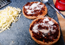 Waffle pizzas sauced parm added.png