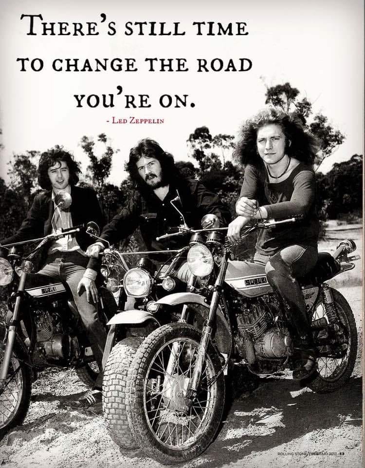 May be a black-and-white image of 3 people, motorcycle and text