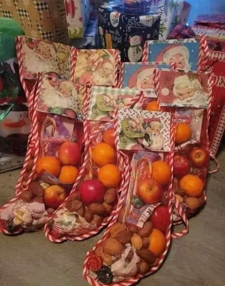 This may contain: three bags filled with fruit sitting on top of a wooden floor next to other items