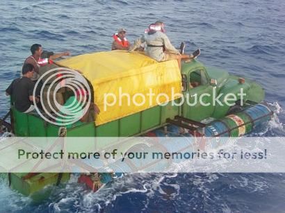 capt.1059000788.migrants_truck_boat_mh103_zpslpgyzasx.jpg