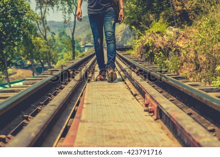 stock-photo-man-jeans-on-railway-walking-forward-423791716.jpg